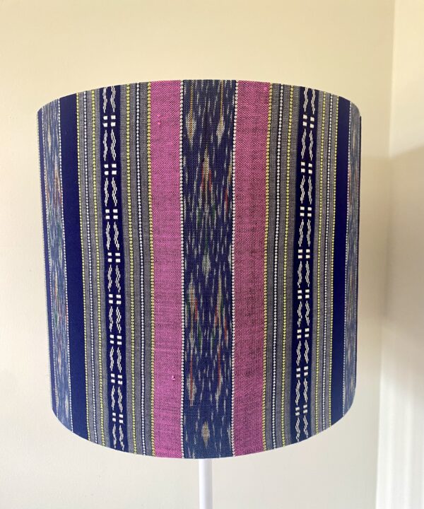 Pink and navy lampshades in a vertical stripe design made from hand-loomed Thai textiles.