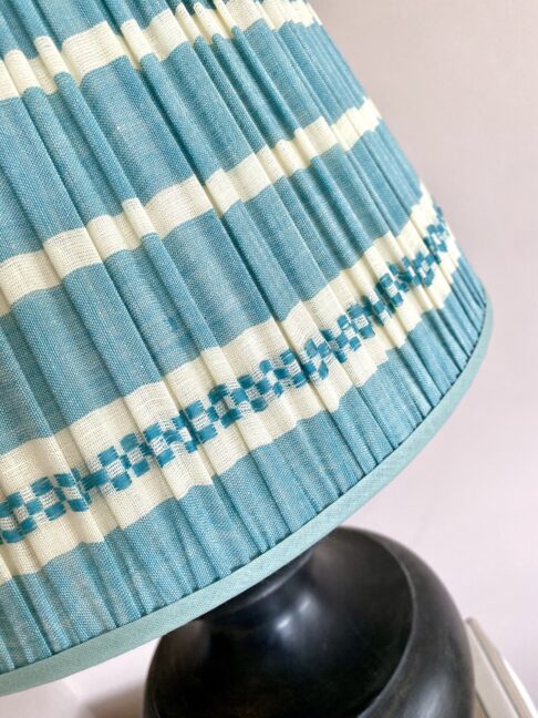 Pale blue gathered lampshades with a blue stripe design, handmade in India.