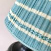 Pale blue gathered lampshades with a blue stripe design, handmade in India.