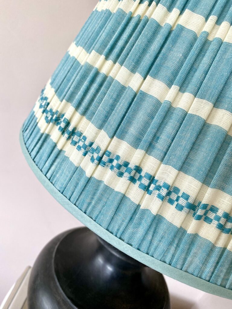 Pale blue gathered lampshades with a blue stripe design, handmade in India.