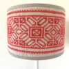 A petite, hand-embroidered vintage lampshade in red on neutral.