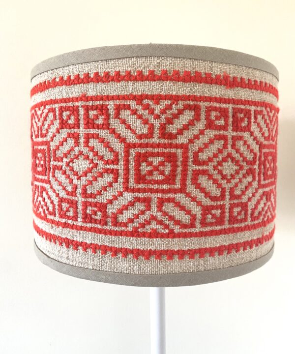 A petite, hand-embroidered vintage lampshade in red on neutral.