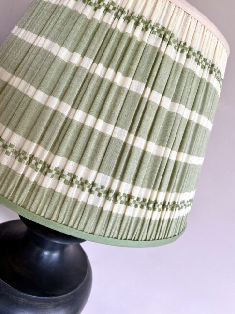 A pretty, sage green pleated lampshade in hand-loomed Indian cotton.