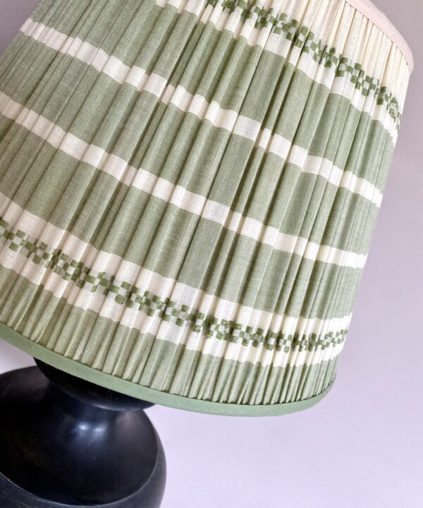 A pretty, sage green pleated lampshade in hand-loomed Indian cotton.