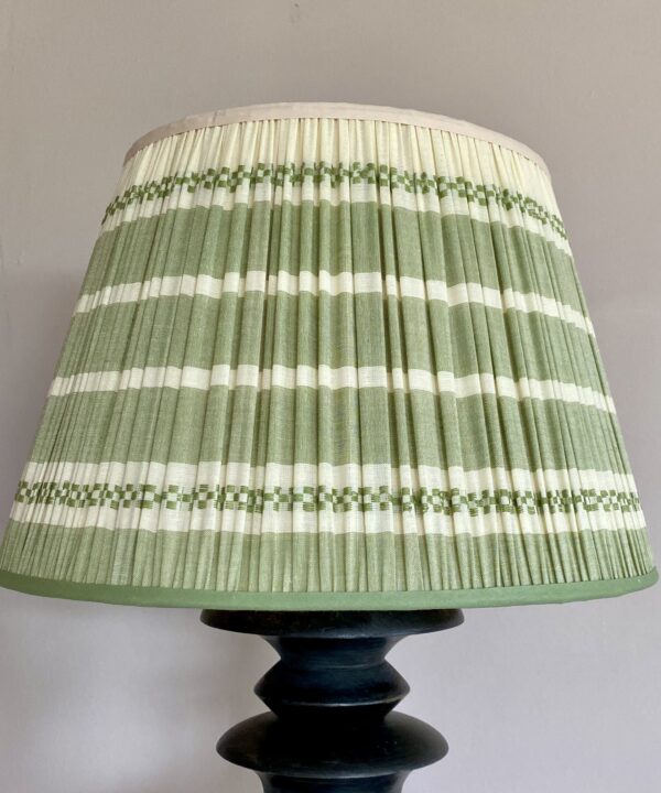 Green gathered lampshade in handwoven cotton with a subtle stripe design.