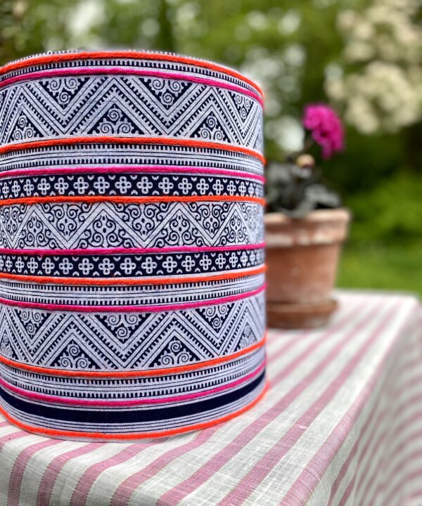 A drum lampshade handmade using a vintage Thai indigo print with pink and orange stripes.