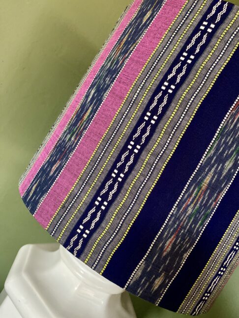 Close up of pink and navy stripes on a silk drum lampshade.