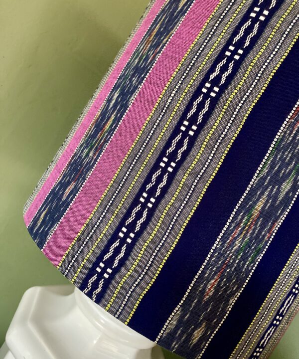 Close up of pink and navy stripes on a silk drum lampshade.