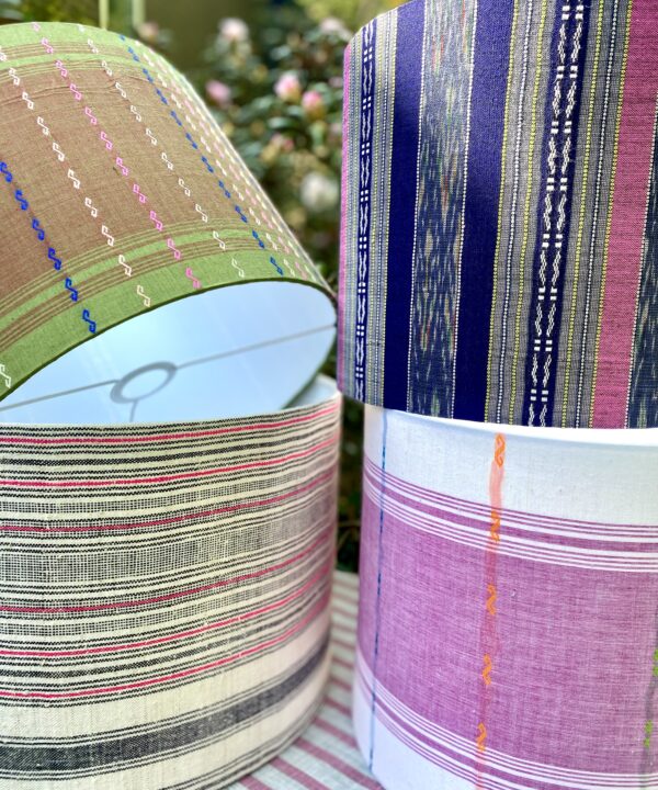 Eclectic lamps and shades: a selection of striped drum lampshades, handmade from Thai textiles.