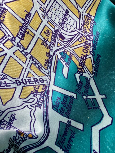 Teal and gold luxury, silk scarf depicting the city of Barcelona.