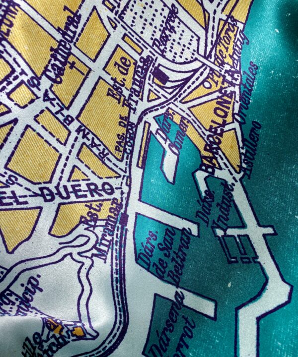 Teal and gold luxury, silk scarf depicting the city of Barcelona.