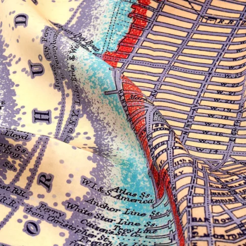 Detail of a lilac silk map print scarf of New York City.