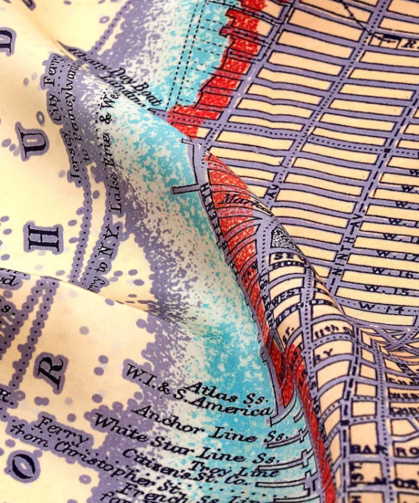 Detail of a lilac silk map print scarf of New York City.