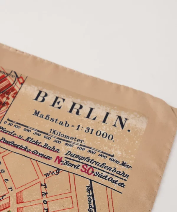 A vintage Berlin map adorns this beige and red, silk twill scarf.