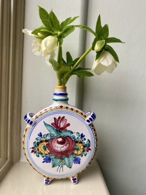 Vintage Portuguese bud vases with hand-painted decoration filled with seasonal Hellebores.