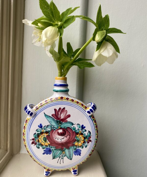 Vintage Portuguese bud vases with hand-painted decoration filled with seasonal Hellebores.