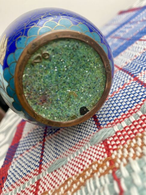 The base of a cloisonné decorated small metal pot.