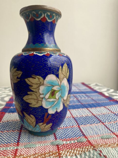 A vintage cloisonné metal vase with floral decoration.