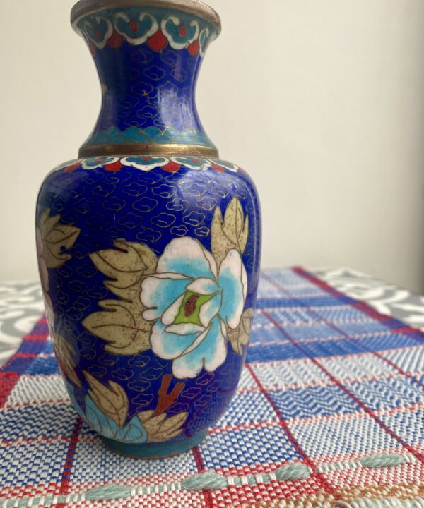 A vintage cloisonné metal vase with floral decoration.