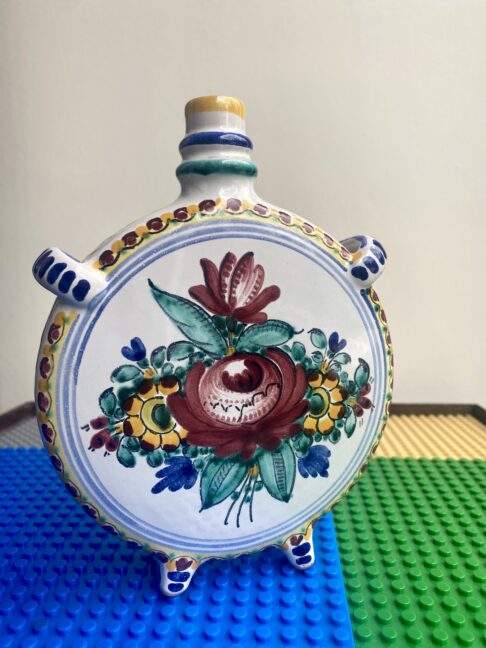 A beautiful, hand-painted rose on a Portuguese pottery vase.