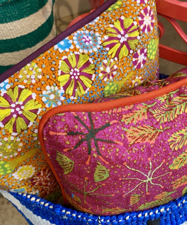 Multi-coloured mini cushions in bold, bright Aboriginal art prints on linen.