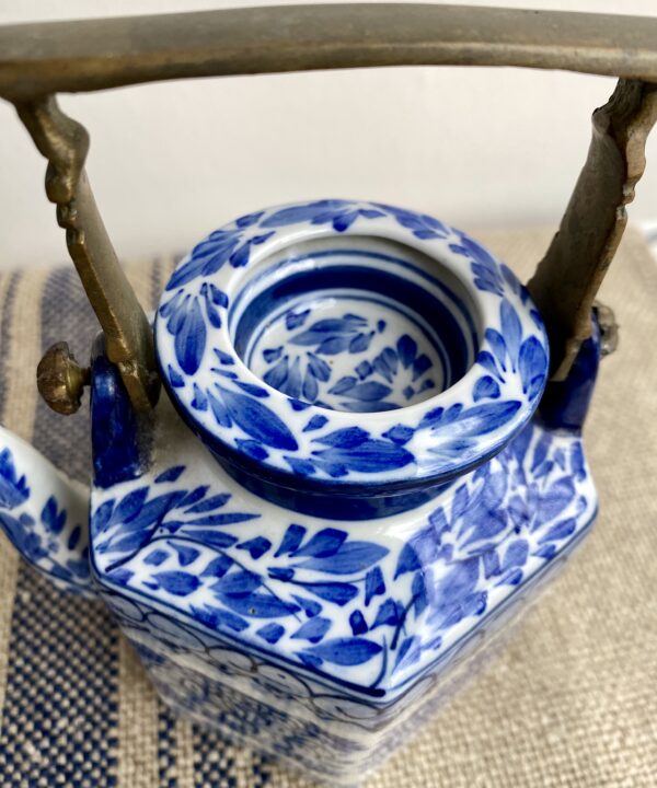Detail of a decorative, hand-painted Thai pottery teapot.