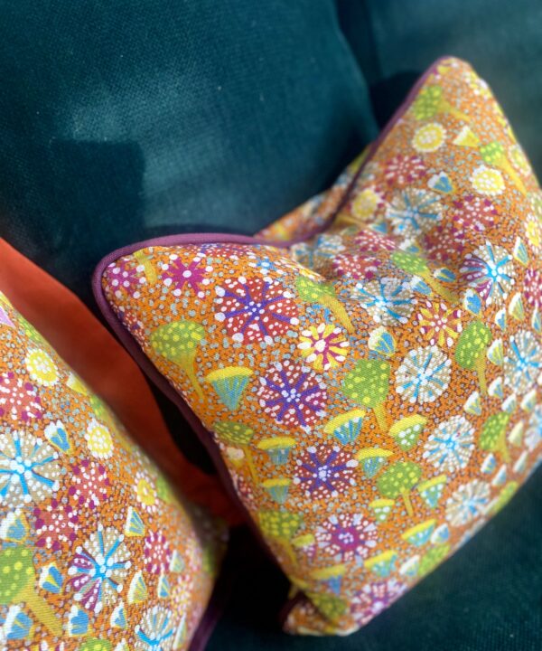 Colourful lumbar cushion with an indigenous Aboriginal art print on linen. with burgundy piping.
