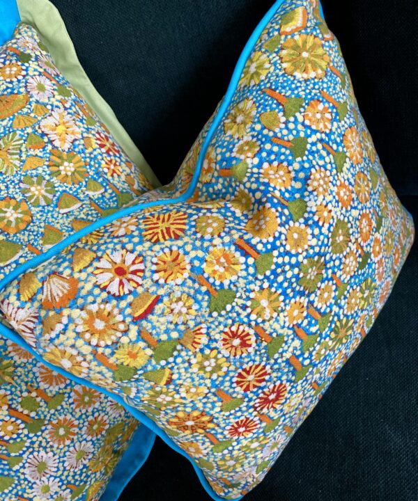 Small lumbar cushion in turquoise, green and yellow floral indigenous Aboriginal art print. Linen fabric with turquoise cotton piping.