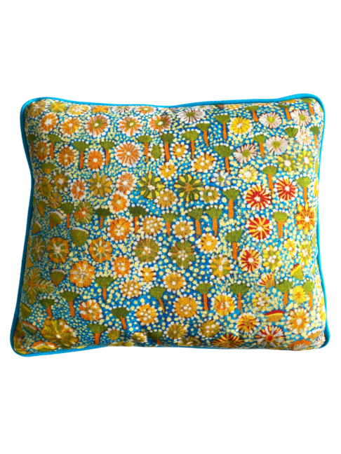 Lumbar mini-cushion with colourful, botanical, Aboriginal art print in Spring green with turquoise trim.