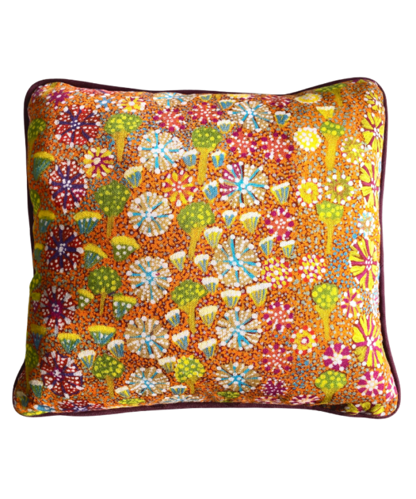 Lumbar mini-cushion with colourful, botanical, Aboriginal art print in orange with burgundy trim.