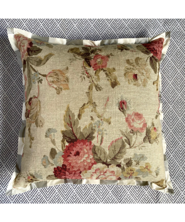 A vintage faded floral cushion cover with a red woven reverse and neutral stripe silk trim.