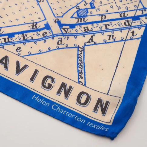 Detail of a vintage map print silk scarf in blue depicting the southern French city Avignon.