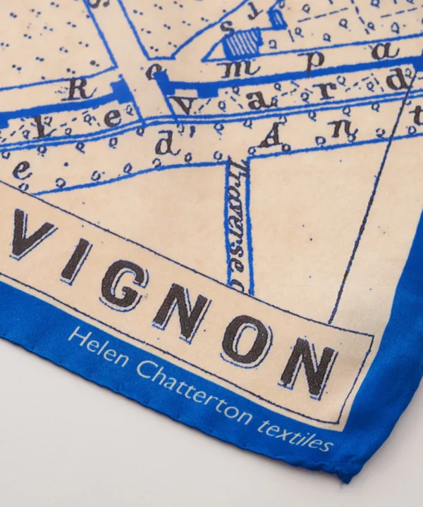 Detail of a vintage map print silk scarf in blue depicting the southern French city Avignon.