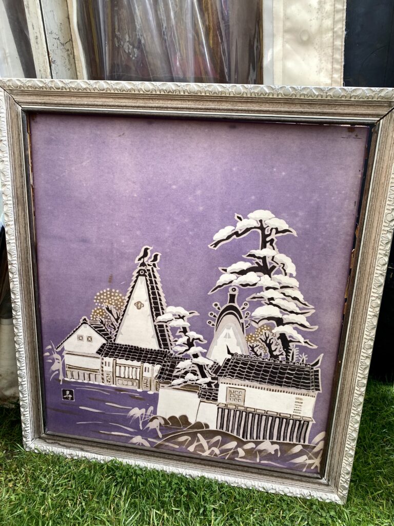 A pretty, lilac, and white Asian landscape painting in a grey frame.