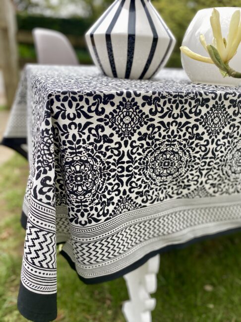 Black and white block-print cotton tablecloths in an outdoor setting.