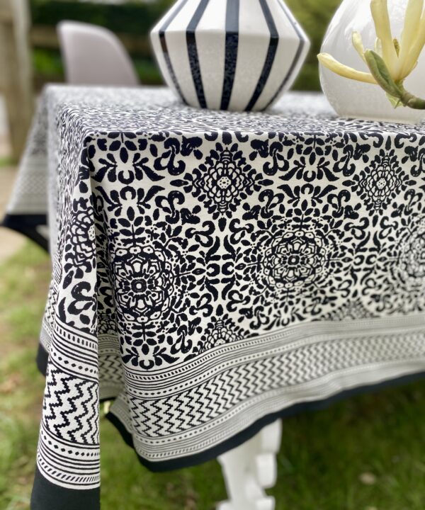 Black and white block-print cotton tablecloths in an outdoor setting.