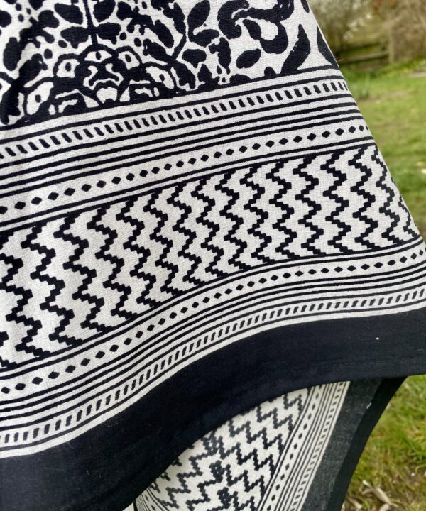 Detail of a geometric border on a black and white block-printed tablecloth.