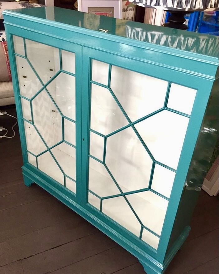 An astragal glazed, vintage cabinet up-cycled with paint in a teal blue.