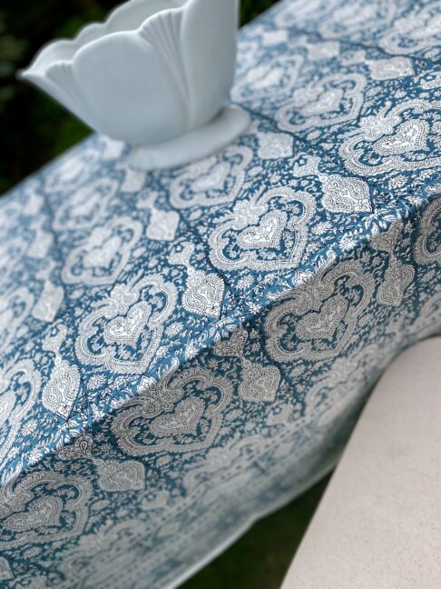 Detail of a blue, block-print tablecloth with an Indian-style pattern.