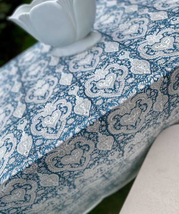 Detail of a blue, block-print tablecloth with an Indian-style pattern.