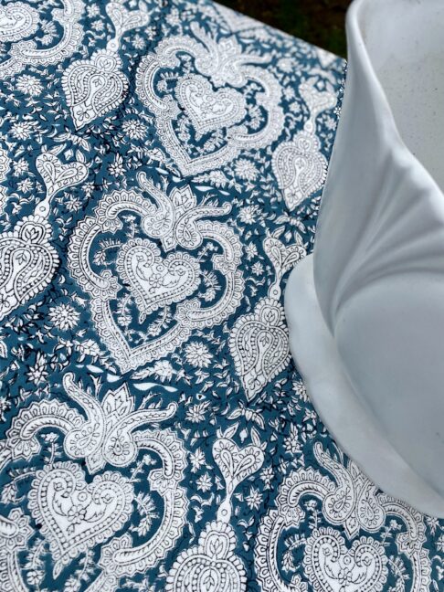 Detail of Mughal-inspired block-print pattern on a pretty tablecloth in a slate blue hue.