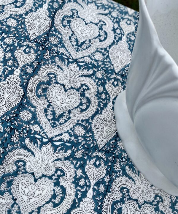 Detail of Mughal-inspired block-print pattern on a pretty tablecloth in a slate blue hue.