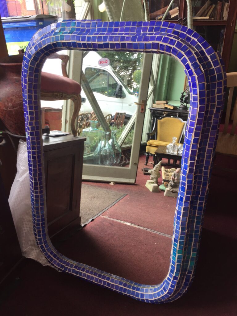 A large, mosaic-tiled, curved mirror in Royal blue spied in a secondhand furniture shop.