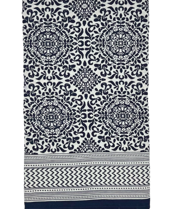 A monochrome Mughal-style, patterned cotton tablecloth with a geometric, zig-zag border.