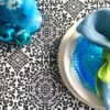 Block-print-cotton tablecloths for a festive table. Black and white pattern underscores a turquoise blue table setting.
