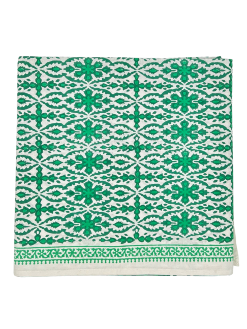 Vibrant, block-print green tablecloth with a decorative border.