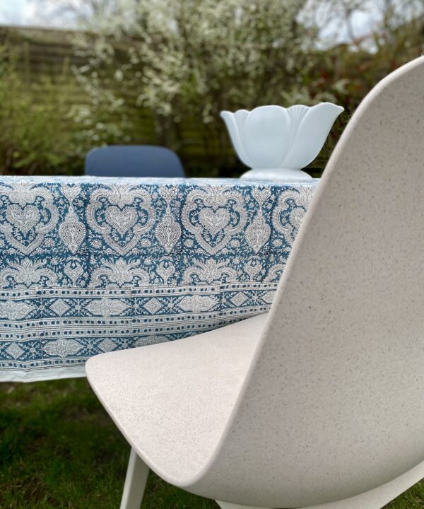 Pretty, blue tablecloths in a traditional, Indian block-print look smart teamed modern chairs in an outdoor dining setting.