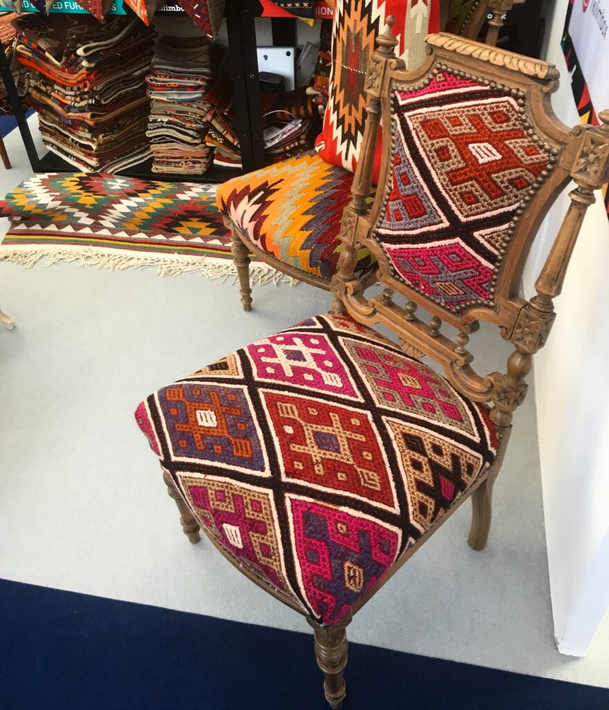 A wooden-framed side or nursing chair, re-upholstered with a striking diamond-design flat weave kilim.