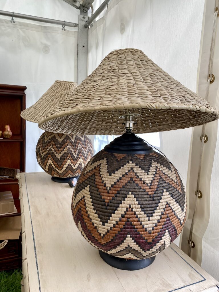 Vintage woven baskets with a zig-zag stripe design, converted into striking lamp bases replete with woven coolie shades.