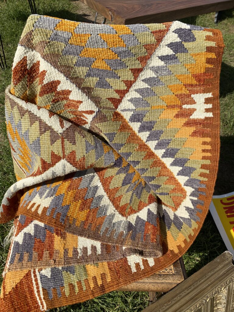 A geometric-patterned kilim flat weave textile spied at an antiques fair.